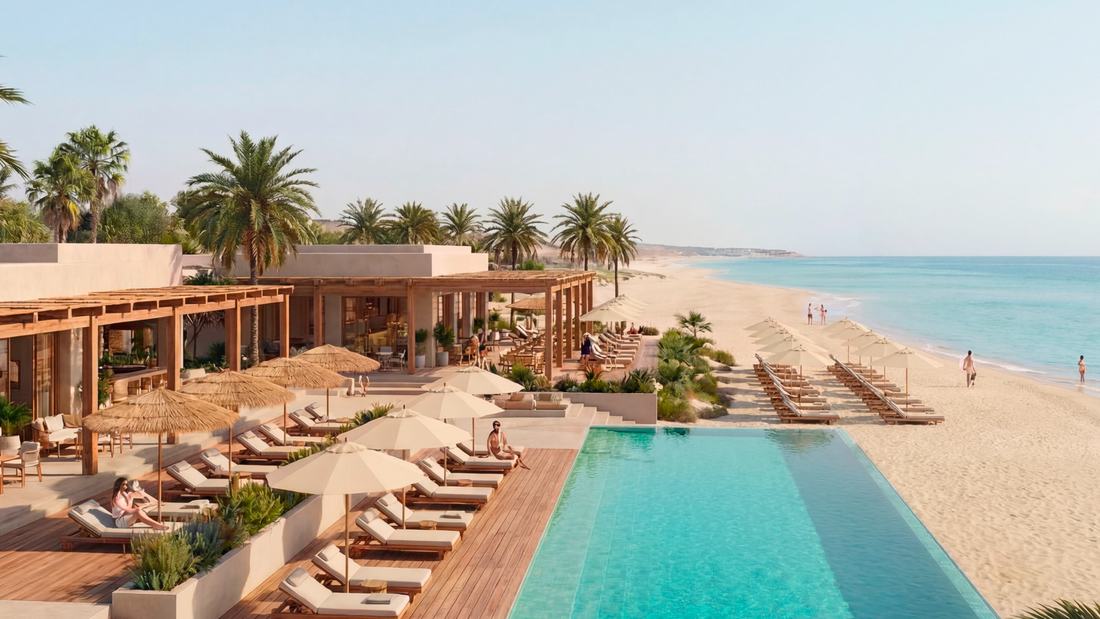 Official Eagle Hills render of a beach club with an infinity pool, sun loungers and umbrellas facing the open sea